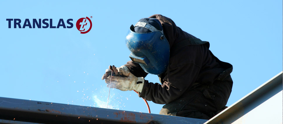 welder welding on metal pipe